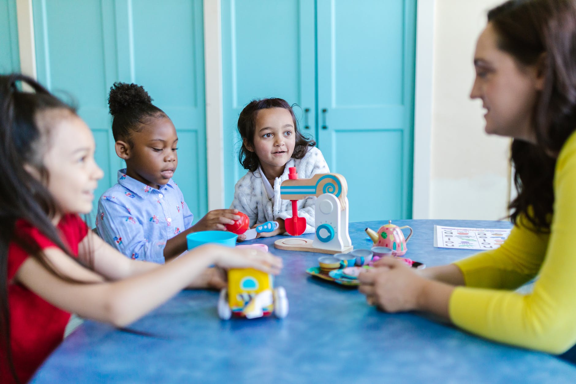 a teacher talking with her pupils